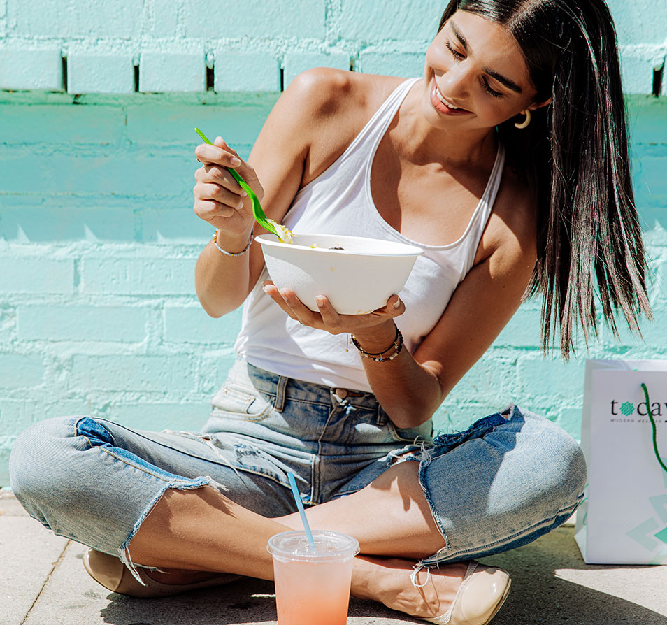 woman eating Tocaya meal bowl