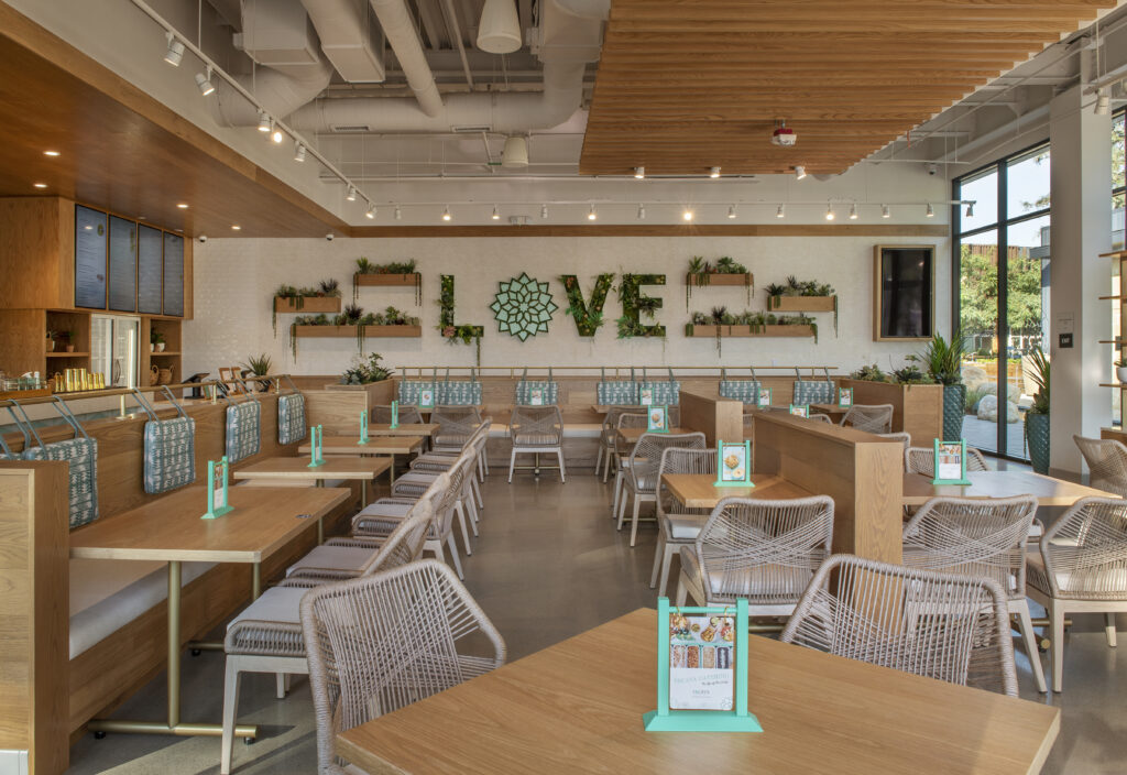 Tocaya interior restaurant view with back wall plant mural spelling LOVE
