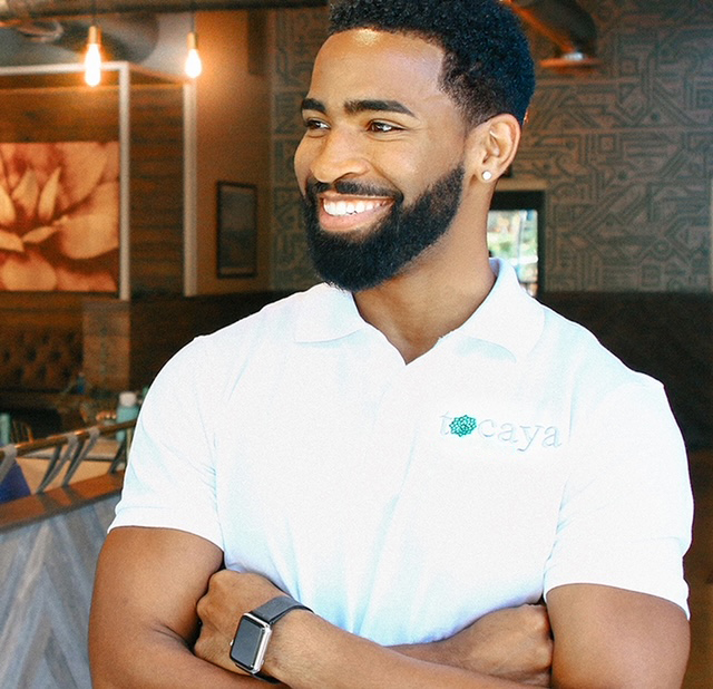 Photo of smiling man with wearing a Tocaya logo polo shirt