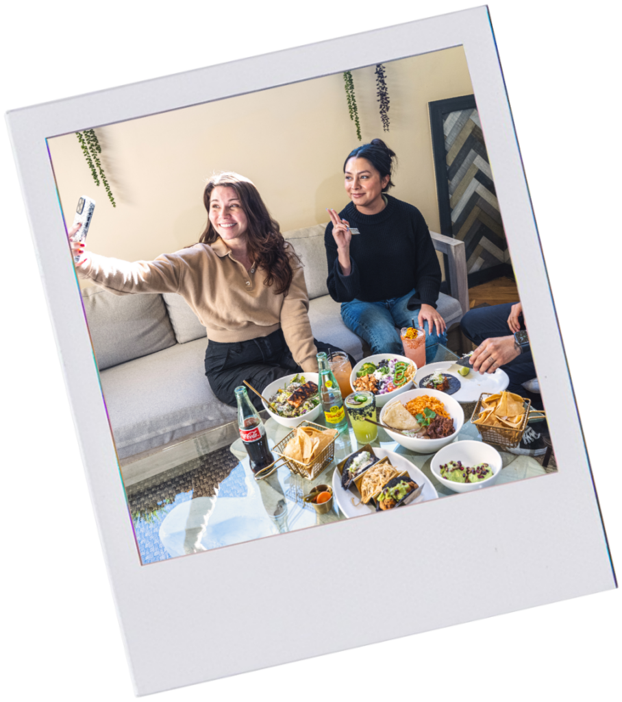 photo of 2 women on couch taking selfie
